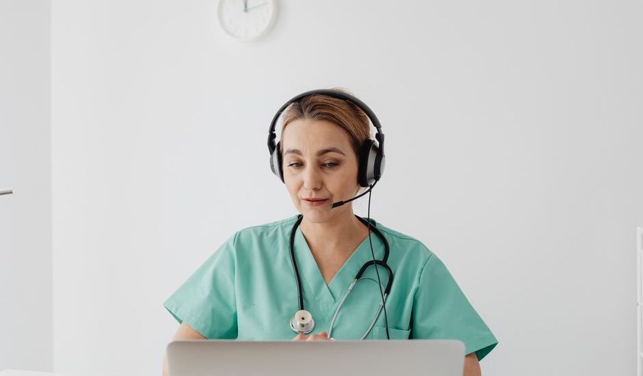 Physician reviewing a practice website on a laptop